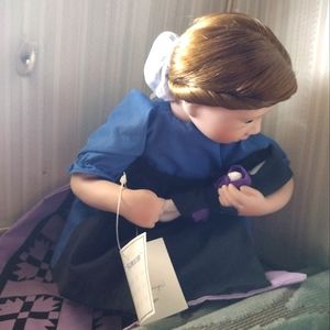 An Amish porcelain doll holding a little baby certification of authenticity
